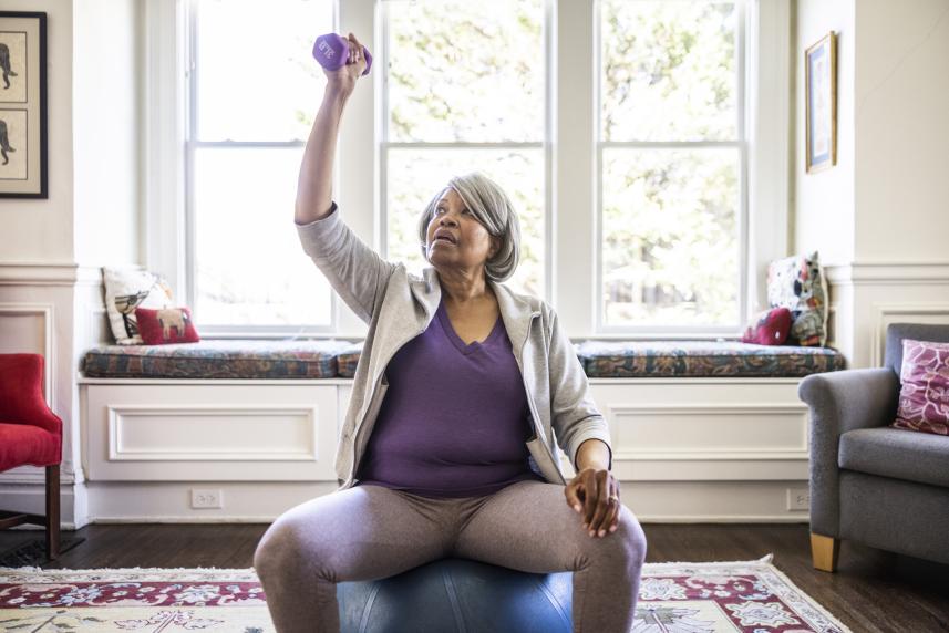 Older woman lifting weights to lose weight to manage diabetes